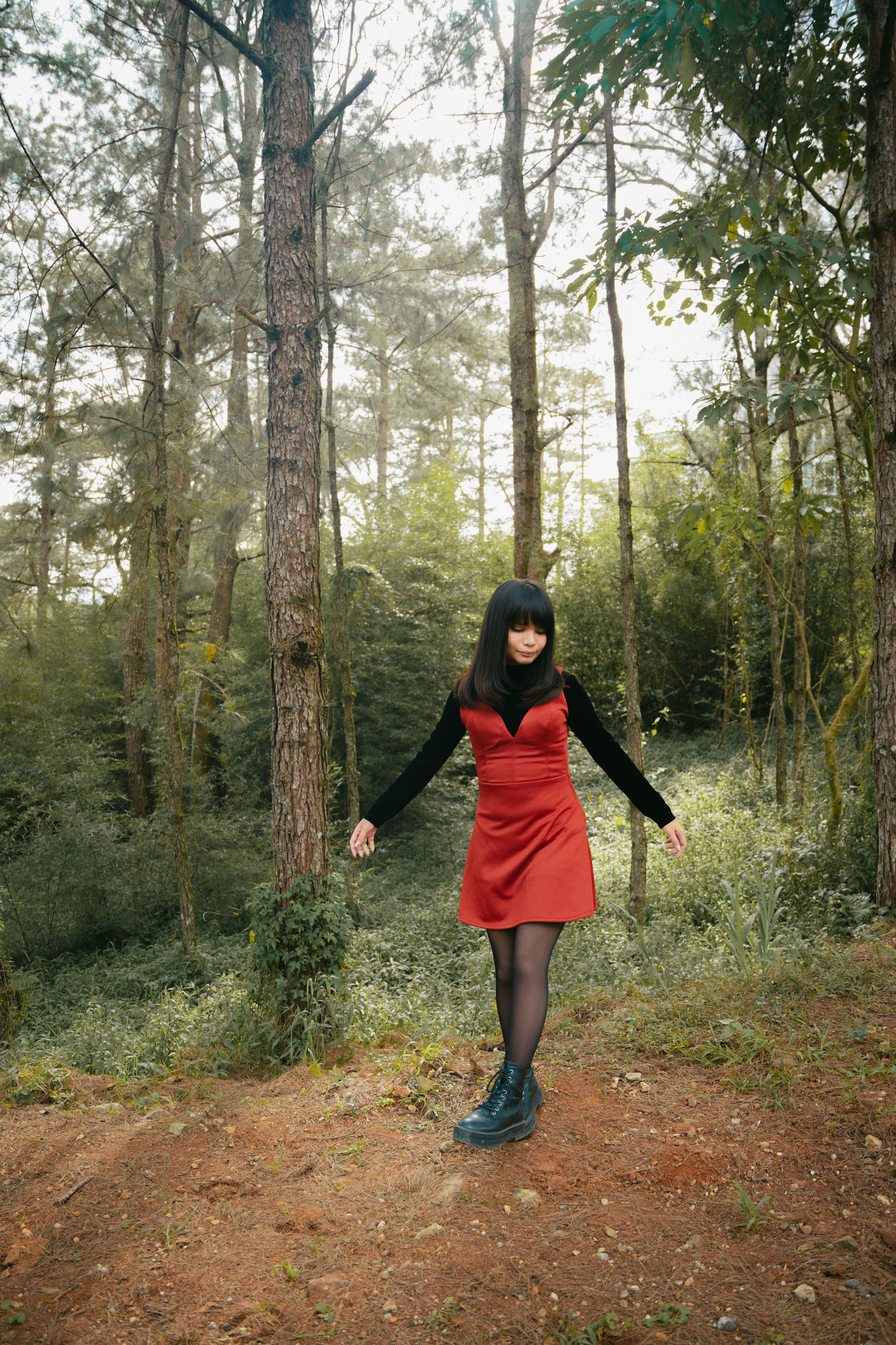 Woman in Red Dress Posing in a Forest · Free Stock Photo