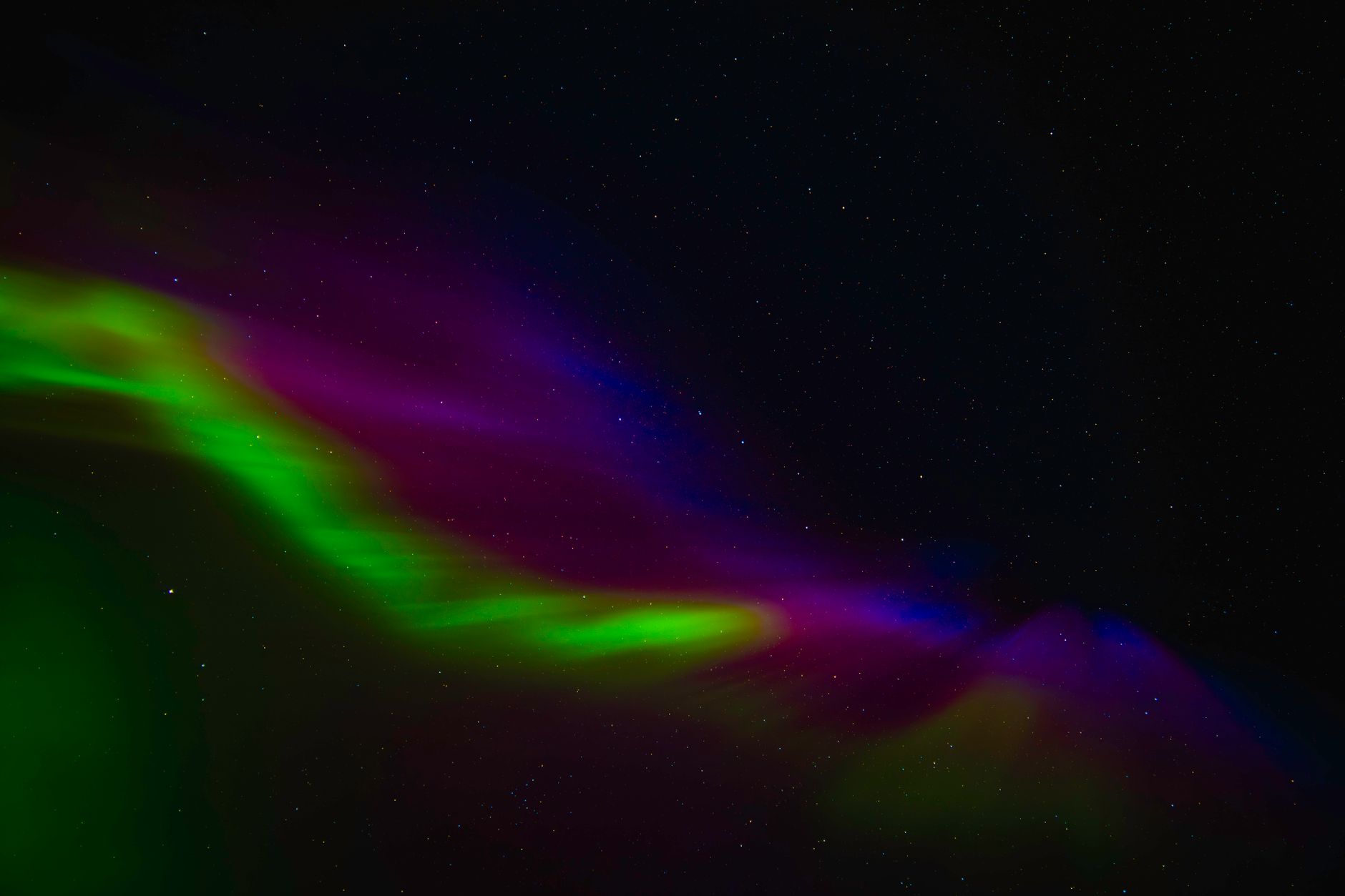 Stunning aurora borealis display with vivid greens, pinks, and blues over Norway's night sky.