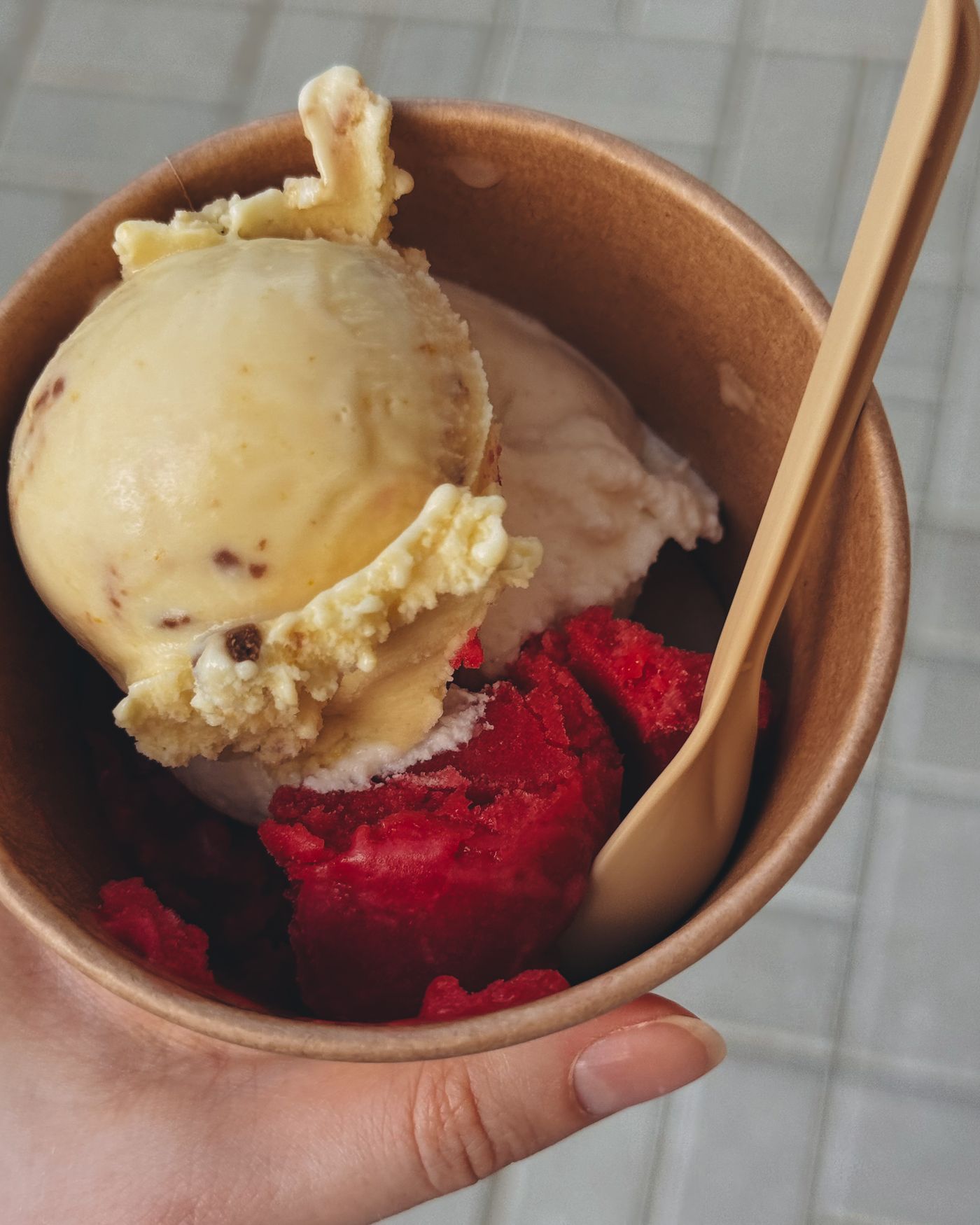 Ice cream served in a printed paper cup as an example of a fiber-forward format