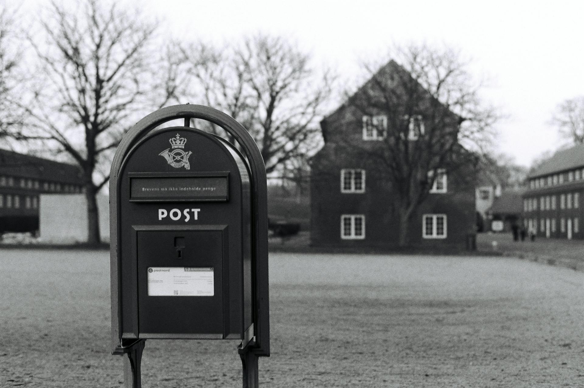 Grayscale Photo of a Post Box
