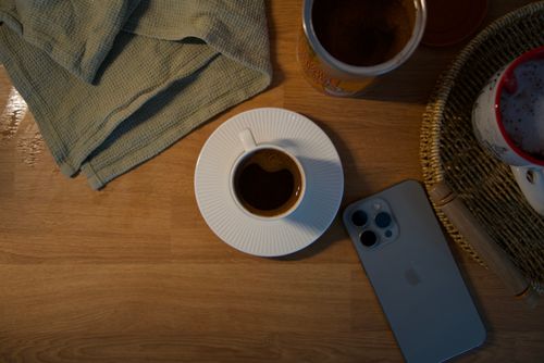 Free Flat lay of coffee cup, smartphone, and mug on wooden table. Stock Photo