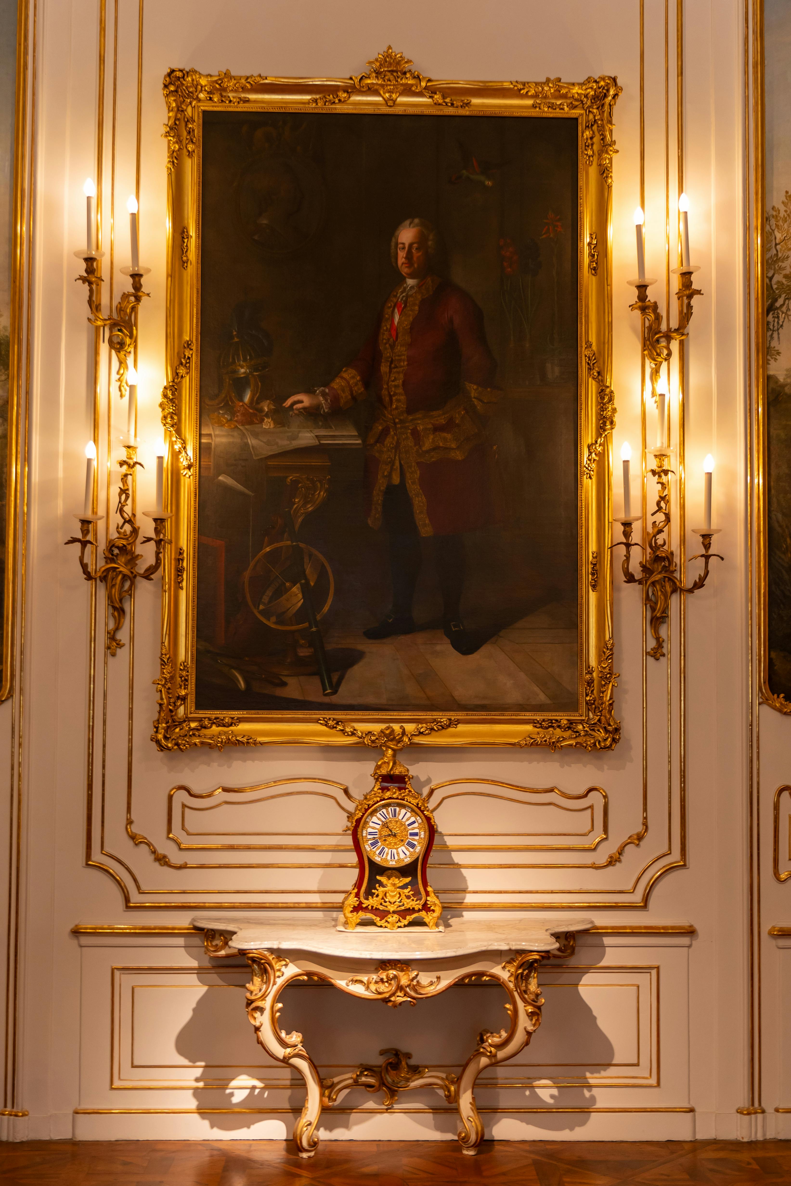 baroque interior with ornate portrait and clock