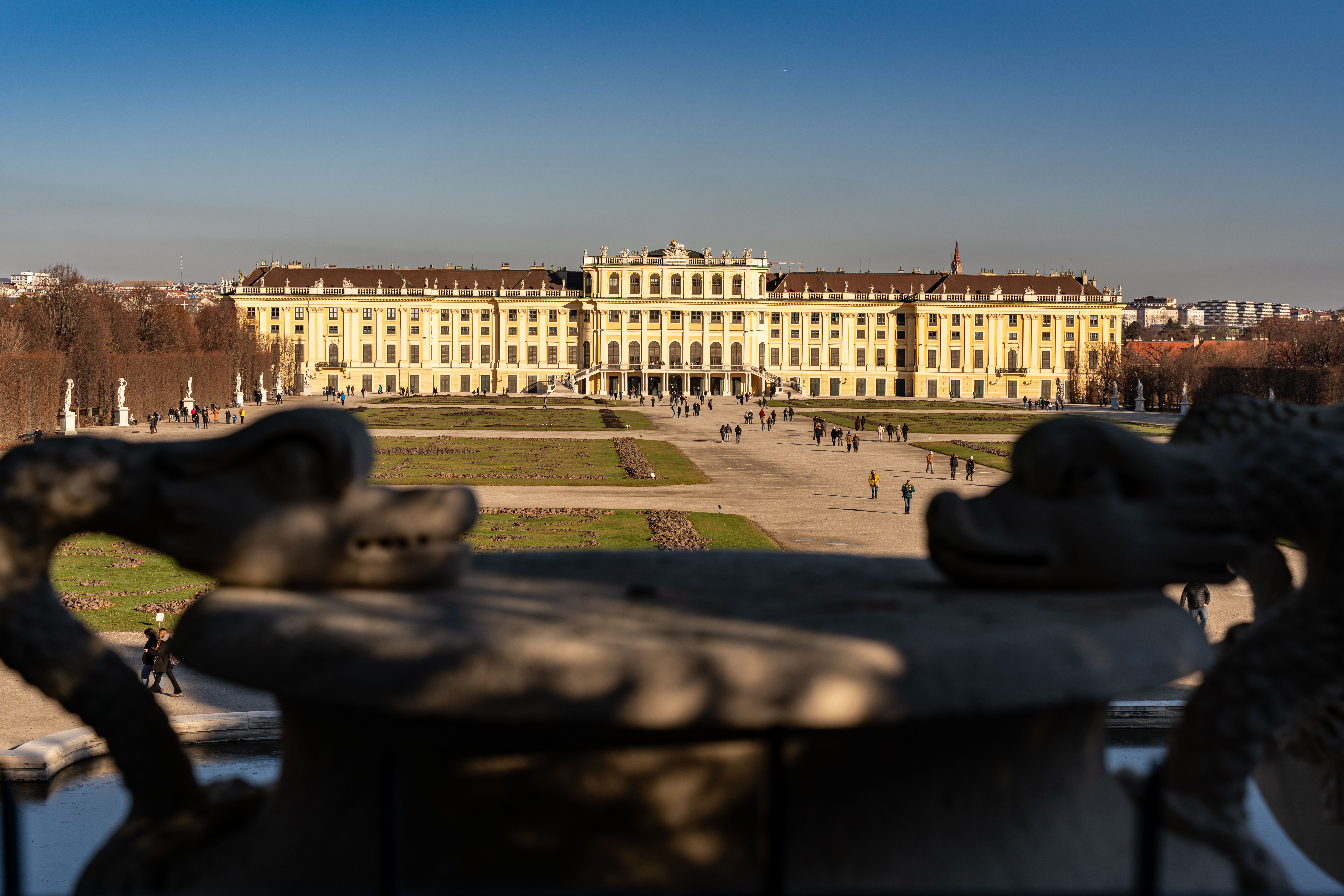 Free Stunning view of Schonbrunn Palace in Vienna captured from its gardens under a clear blue sky. Stock Photo