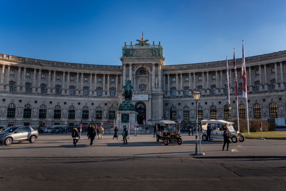 People walking on a vibrant street in Vienna, Austria, representing typical travel scenarios for insurance