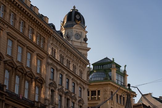 Elegant historic architecture of an iconic building in Vienna, showcasing detailed design under clear blue skies.