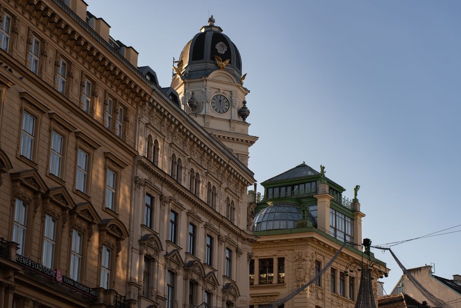 Elegant historic architecture of an iconic building in Vienna, showcasing detailed design under clear blue skies.