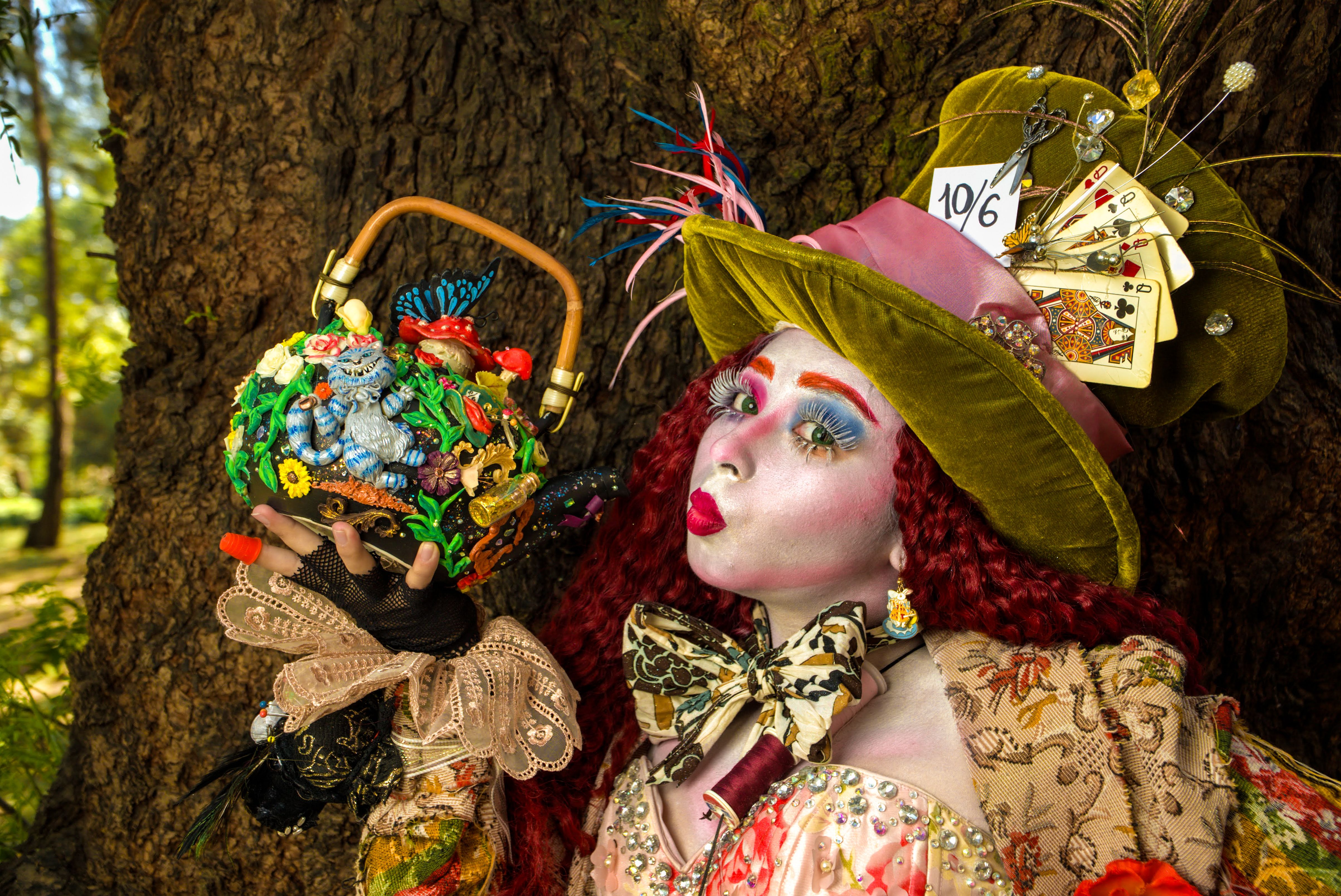 [ColoSach]-colorful-mad-hatter-inspired-cosplay-outfit-with-detailed-makeup-and-accessories-in-an-outdoor-setting.