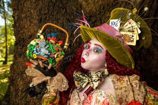 Colorful Mad Hatter inspired cosplay outfit with detailed makeup and accessories in an outdoor setting.