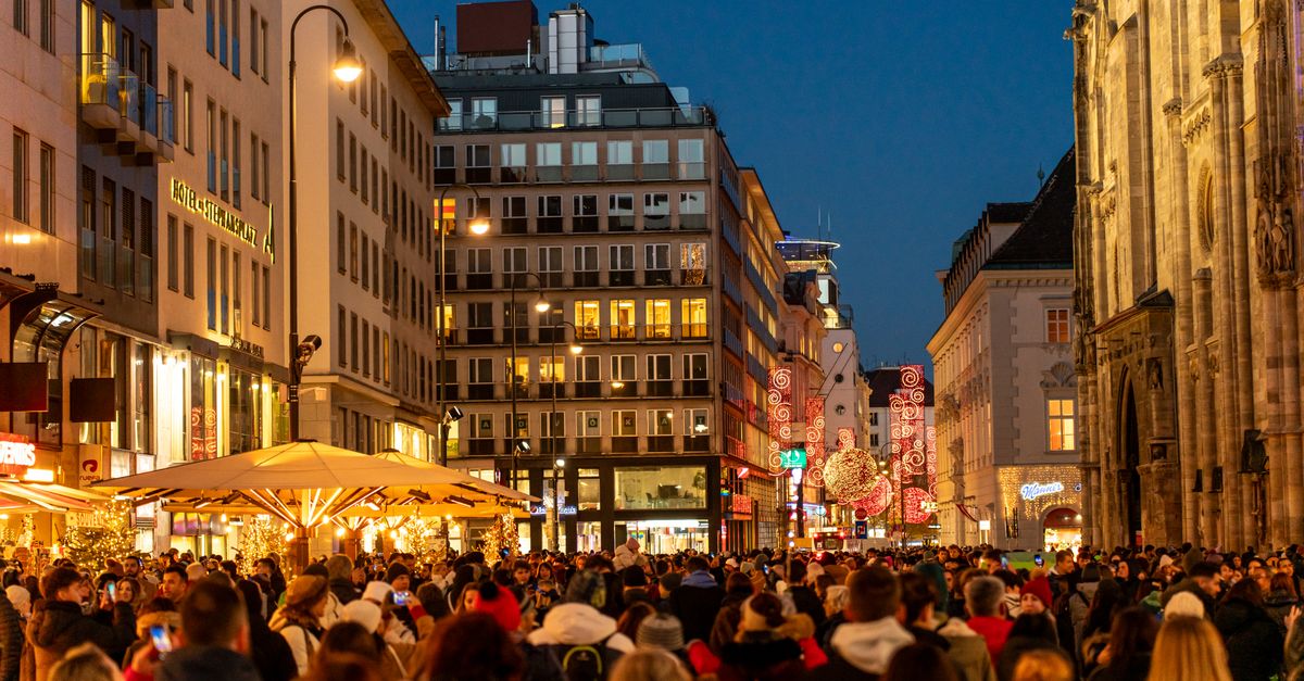 A bustling night scene with a festive crowd in Vienna's vibrant city center.