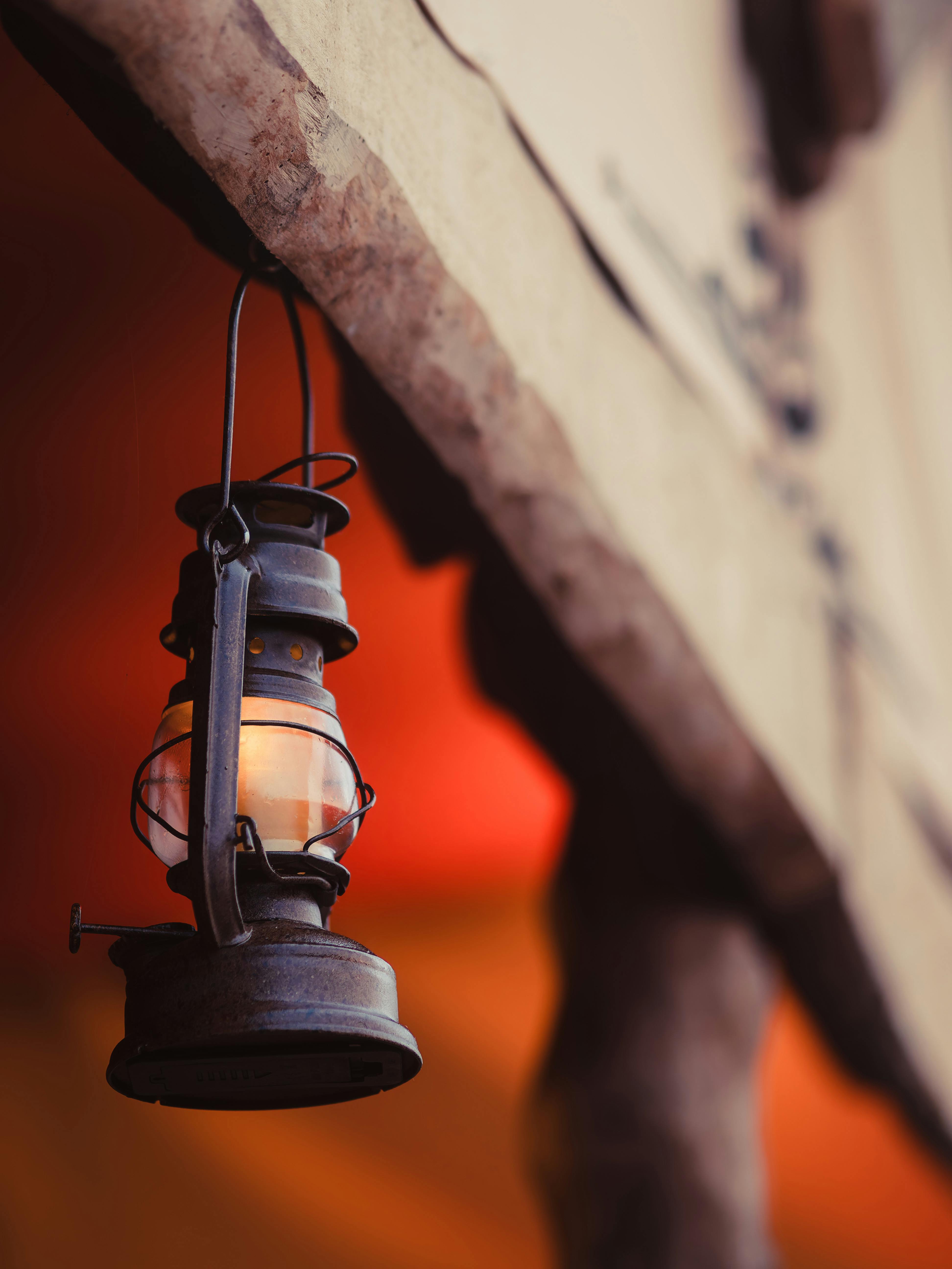 vintage lantern hanging from rustic roof eaves