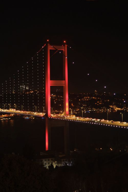 Free Stunning night view of the Bosphorus Bridge glowing in red lights. Stock Photo