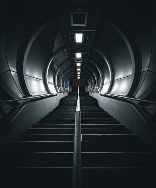 Free A dramatic view of a futuristic tunnel staircase with a dark, moody ambiance in Dubai. Stock Photo