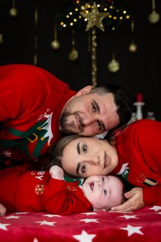 A joyful family enjoying Christmas together in matching festive sweaters.