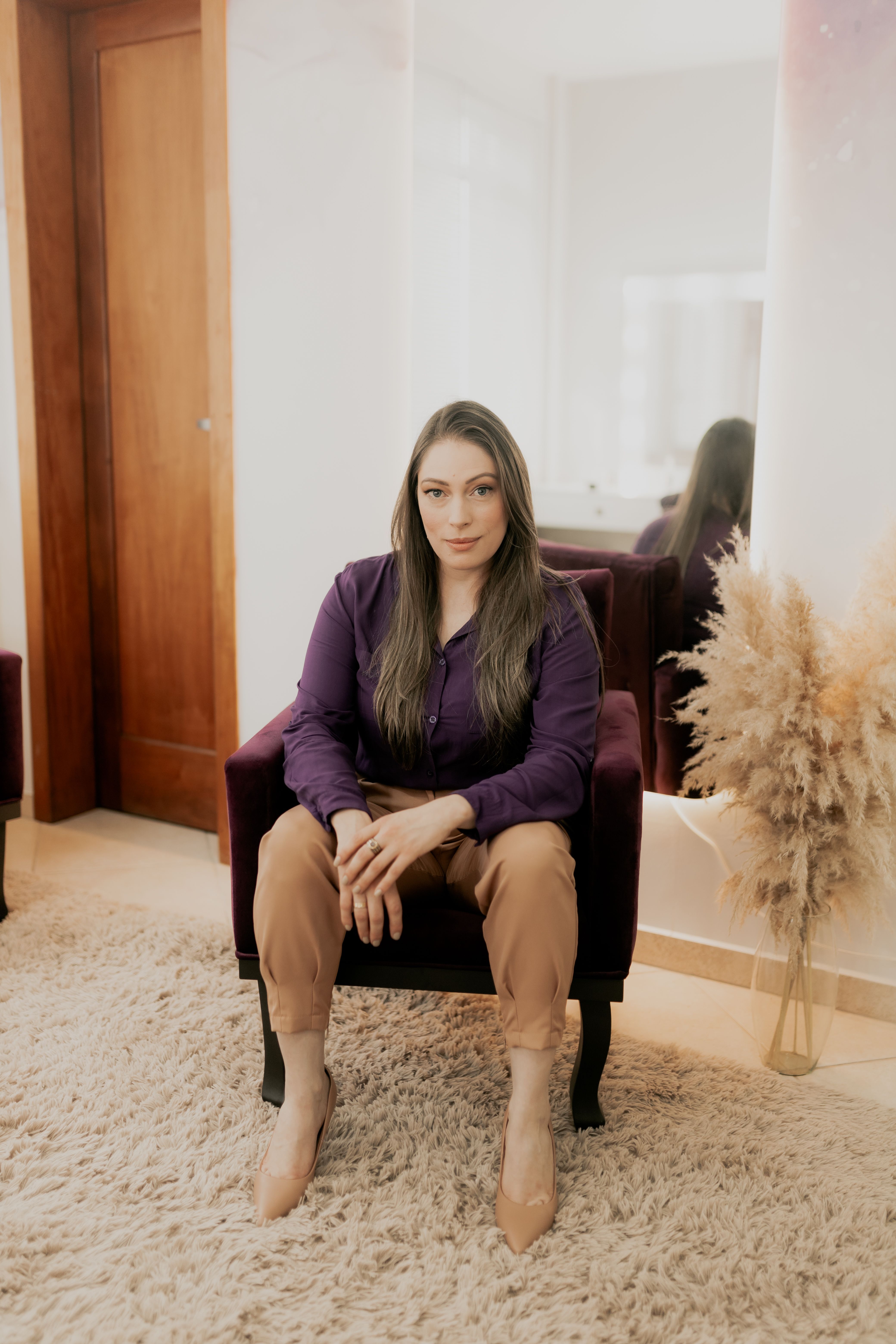 Woman Sitting in Elegant Indoor Setting · Free Stock Photo