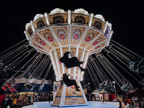 Free Colorful carousel spinning at Berlin's festive Christmas market during the night. Stock Photo