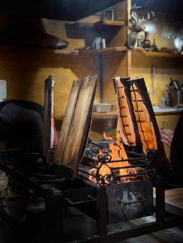 Salmon fillets grilling over open fire in Berlin's Christmas market.