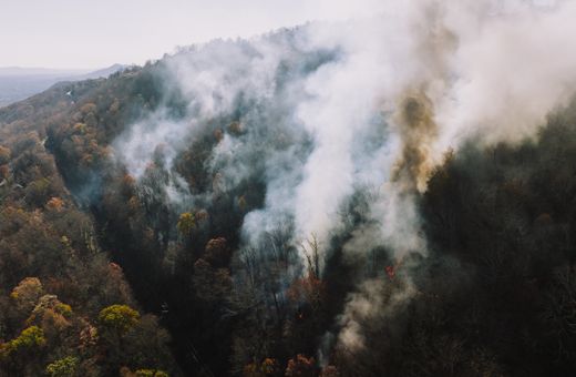 Smoke rising from forested hills