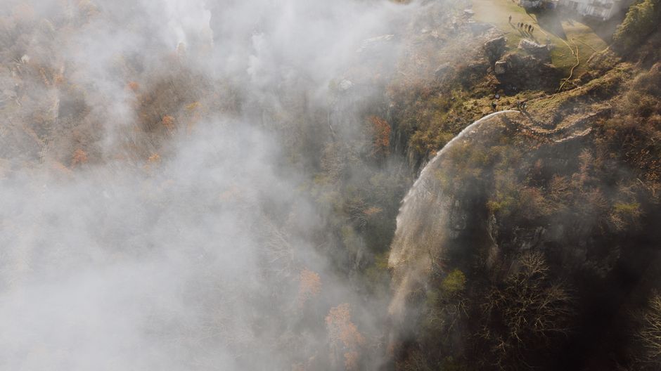 Spectacular 5-Day Ultimate Triple Country Safari: Zimbabwe, Zambia & Botswana Review Review 2026 - Dramatic aerial view of a waterfall cascading amidst fog and autumn foliage.