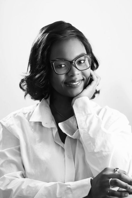 Free Black and white portrait of a woman with glasses in a casual pose. Stock Photo