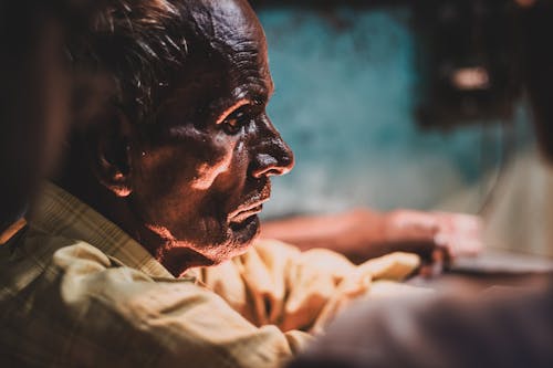 Shallow Focus Photography of Man in Yellow Top Facing Sideways