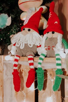 Two charming knitted gnomes with Santa hats add festive cheer, perfect for holiday decor.