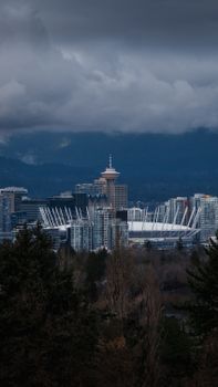 Vancouver skyline with clouds over downtown and iconic landmarks.