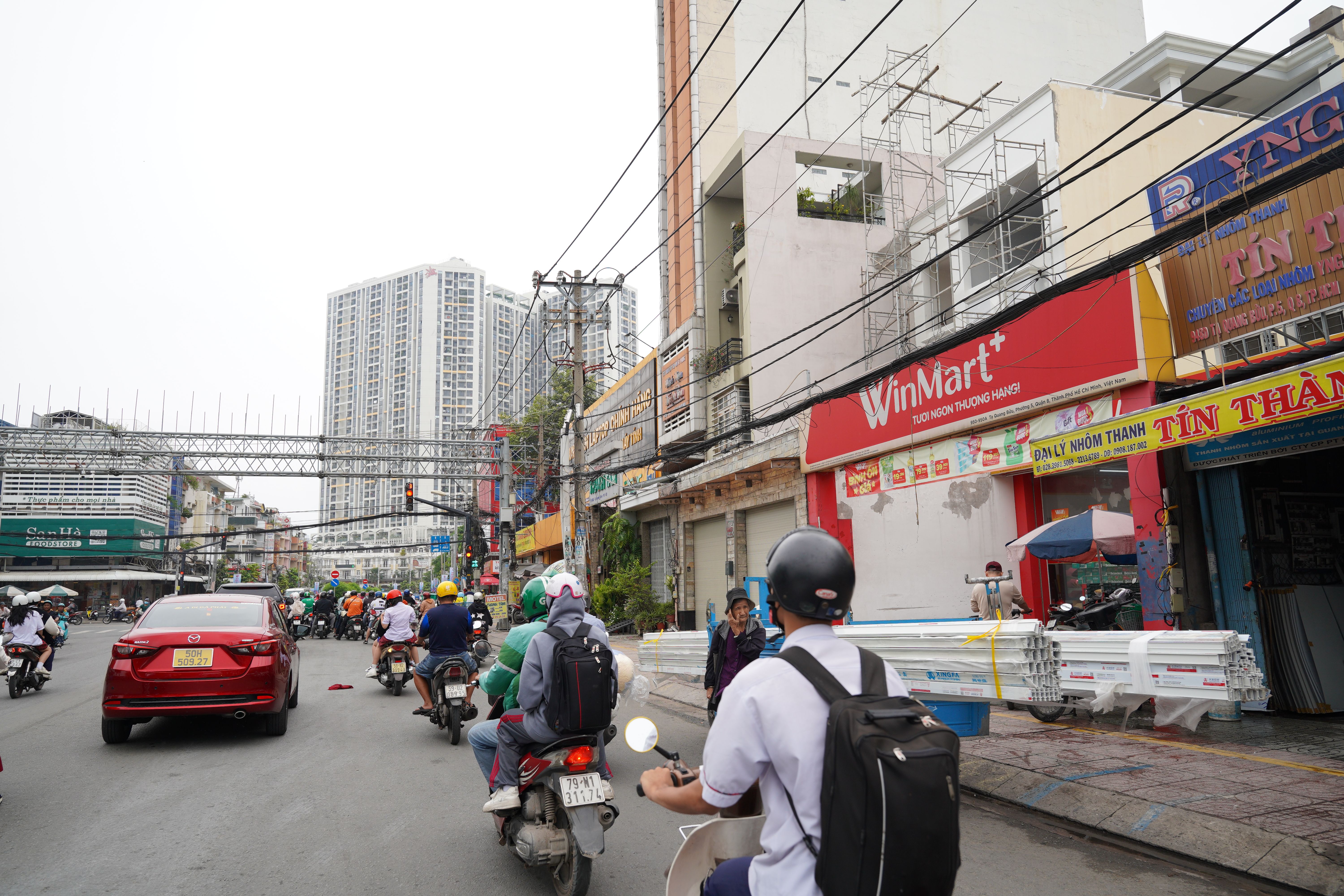 Busy Urban Street with Motorcyclists and Shops