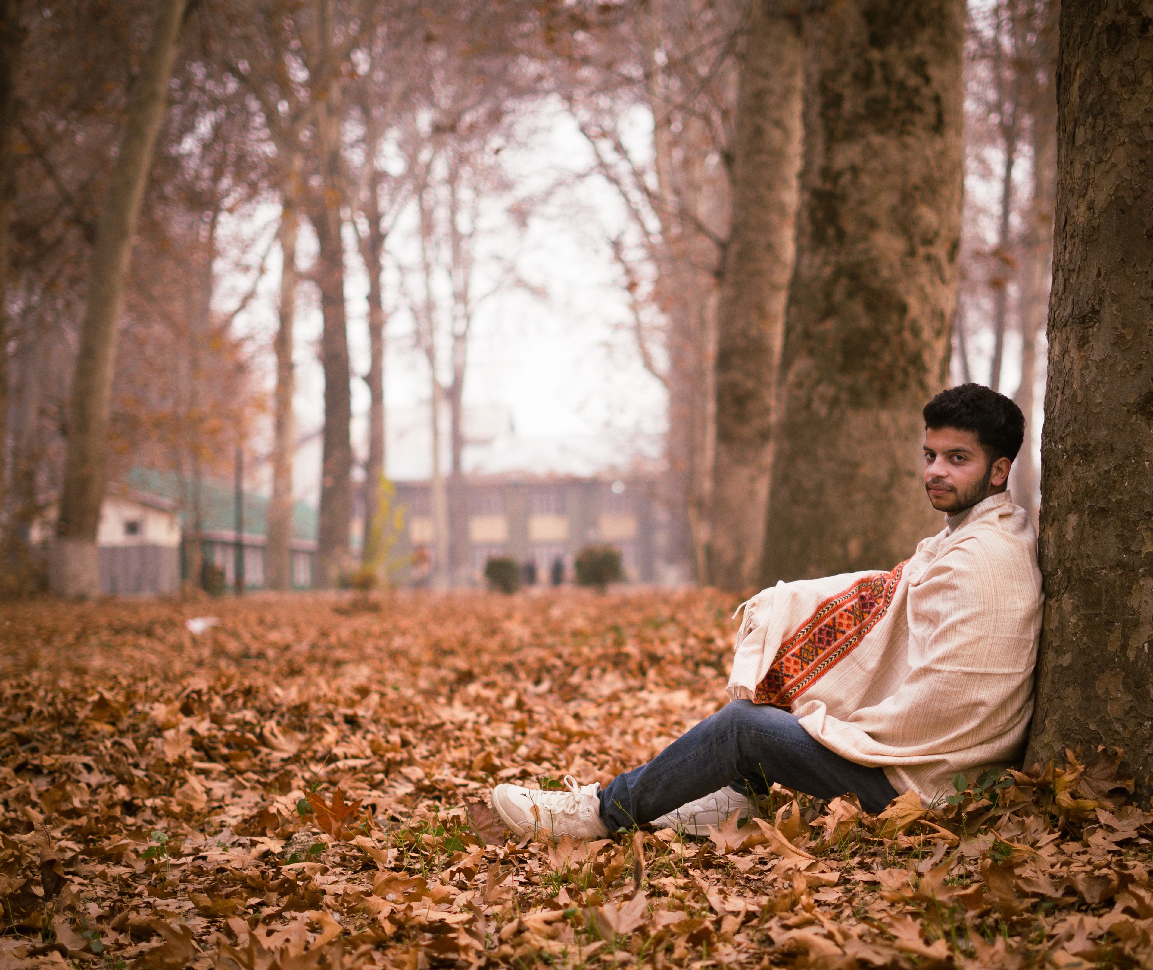 Man Relaxing on Autumn Leaves in Srinagar Park · Free Stock Photo