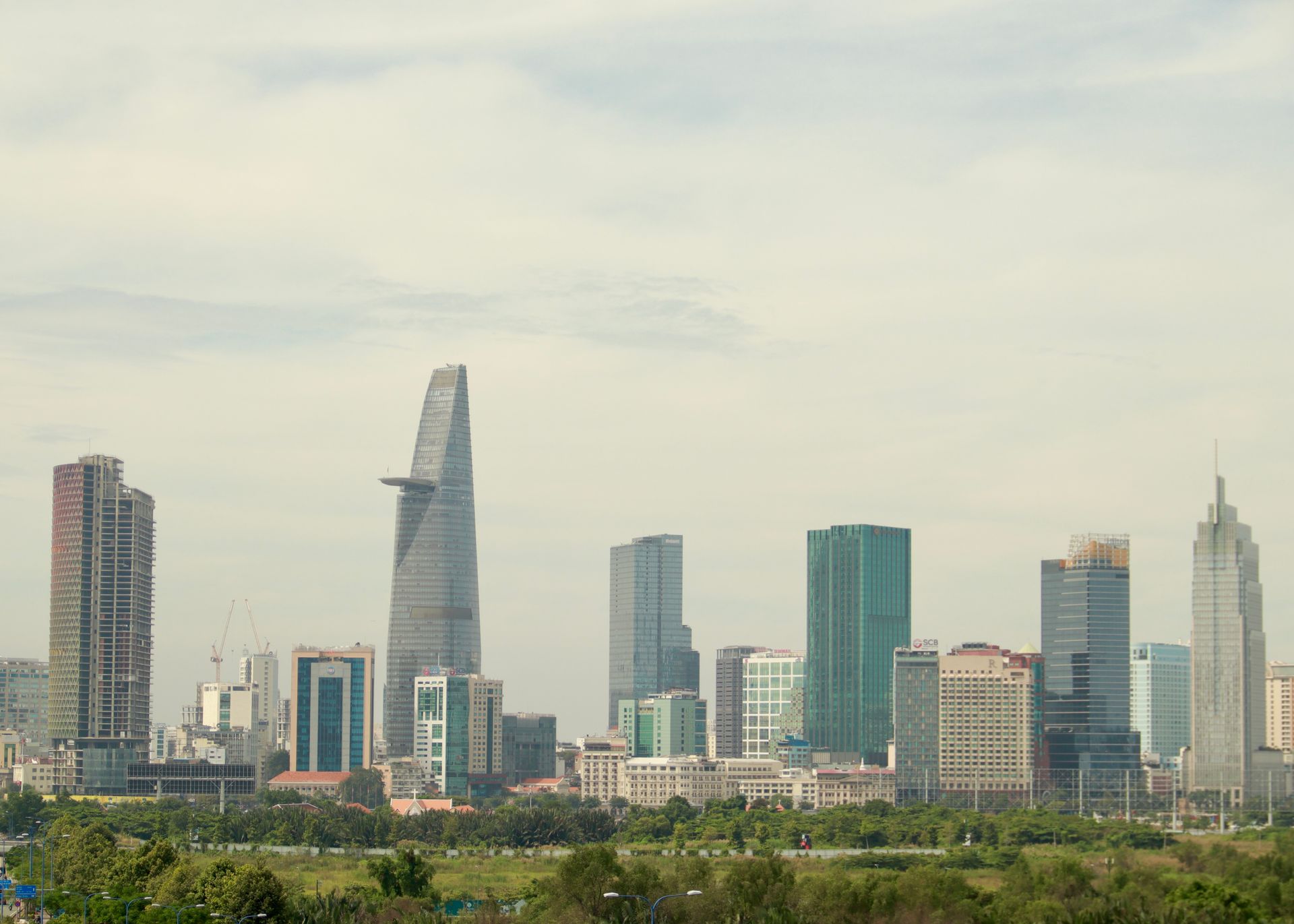 Skyline view of modern buildings with Bitexco Financial Tower in front.