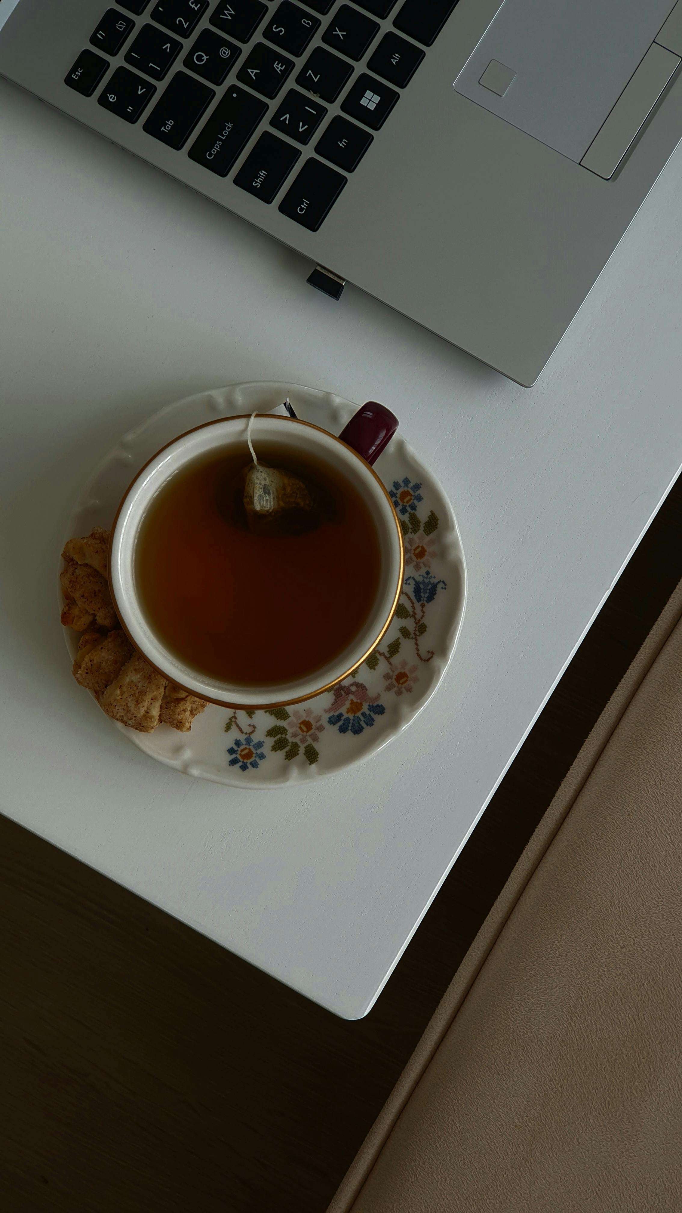 cozy tea break with laptop on desk