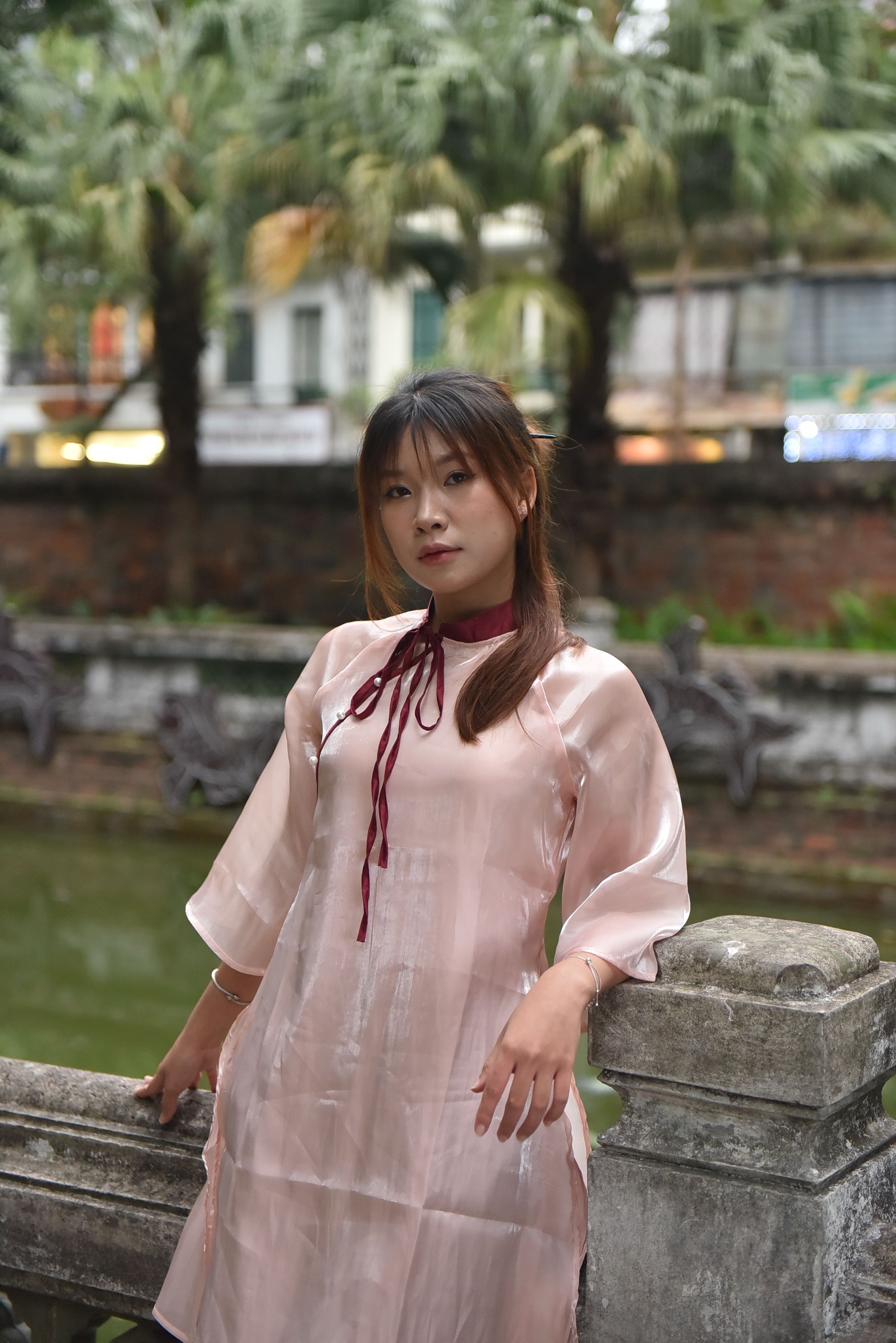 Elegant Woman in Traditional Dress by a Pond · Free Stock Photo