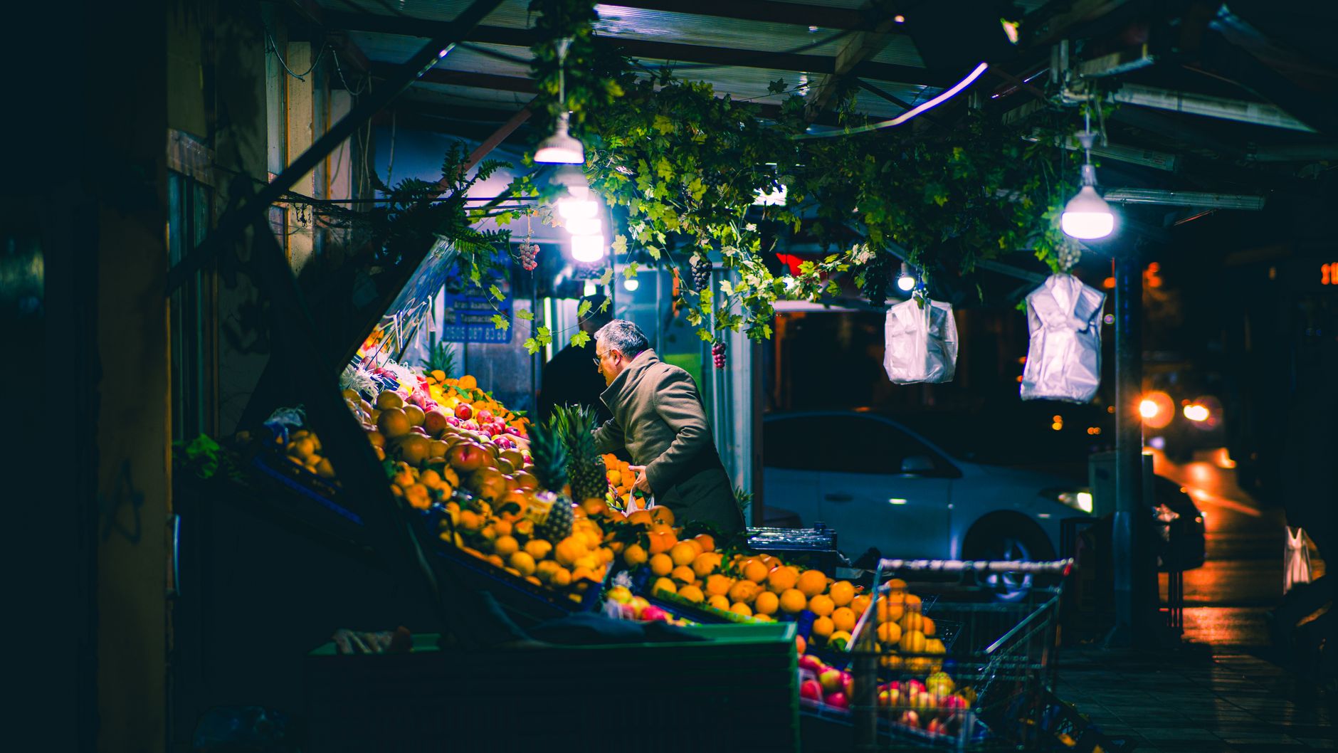 Evening shoppers and parked cars outside the M Block Market arcade in Greater Kailash I, South Delhi