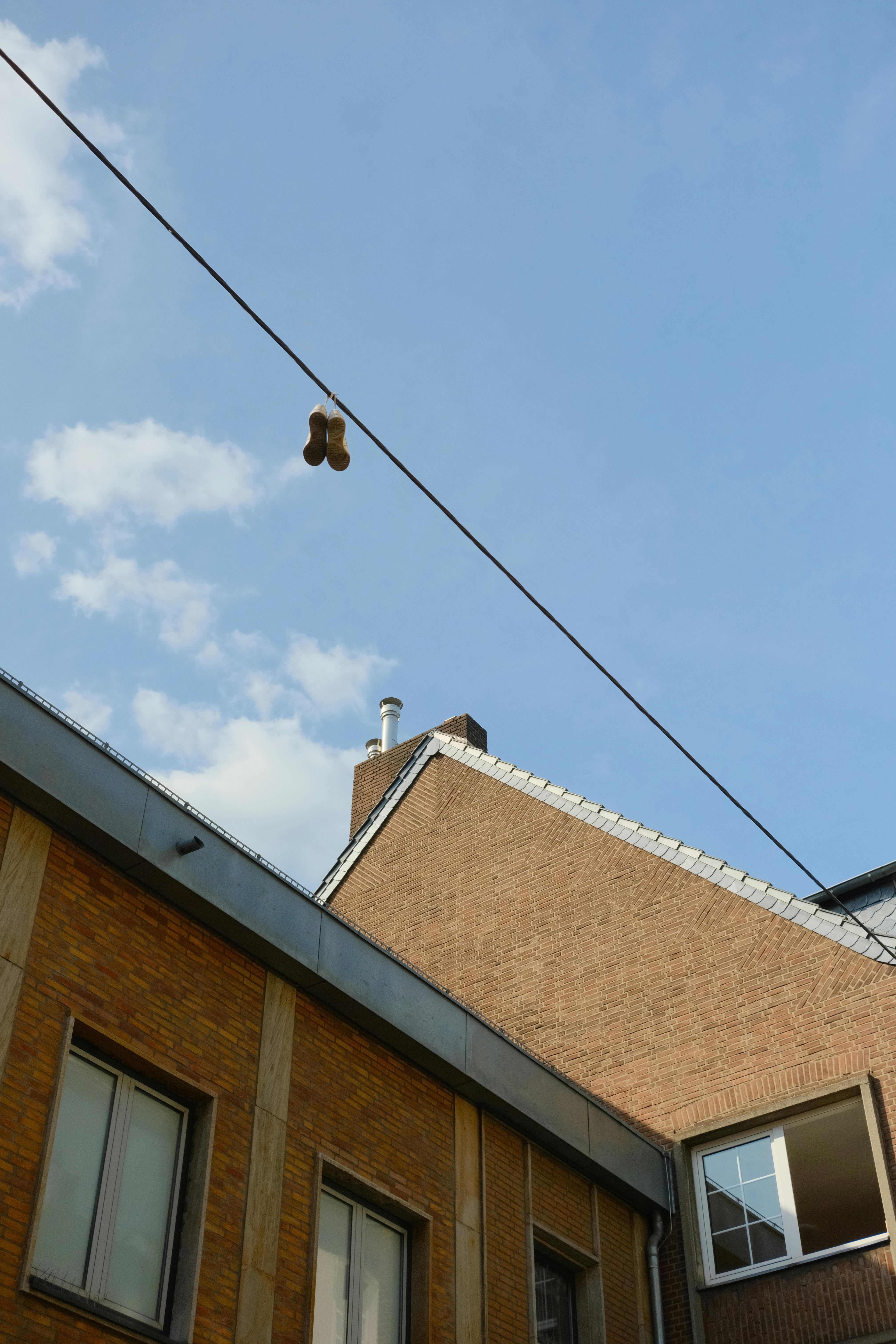 urban scene with hanging shoes and brick buildings