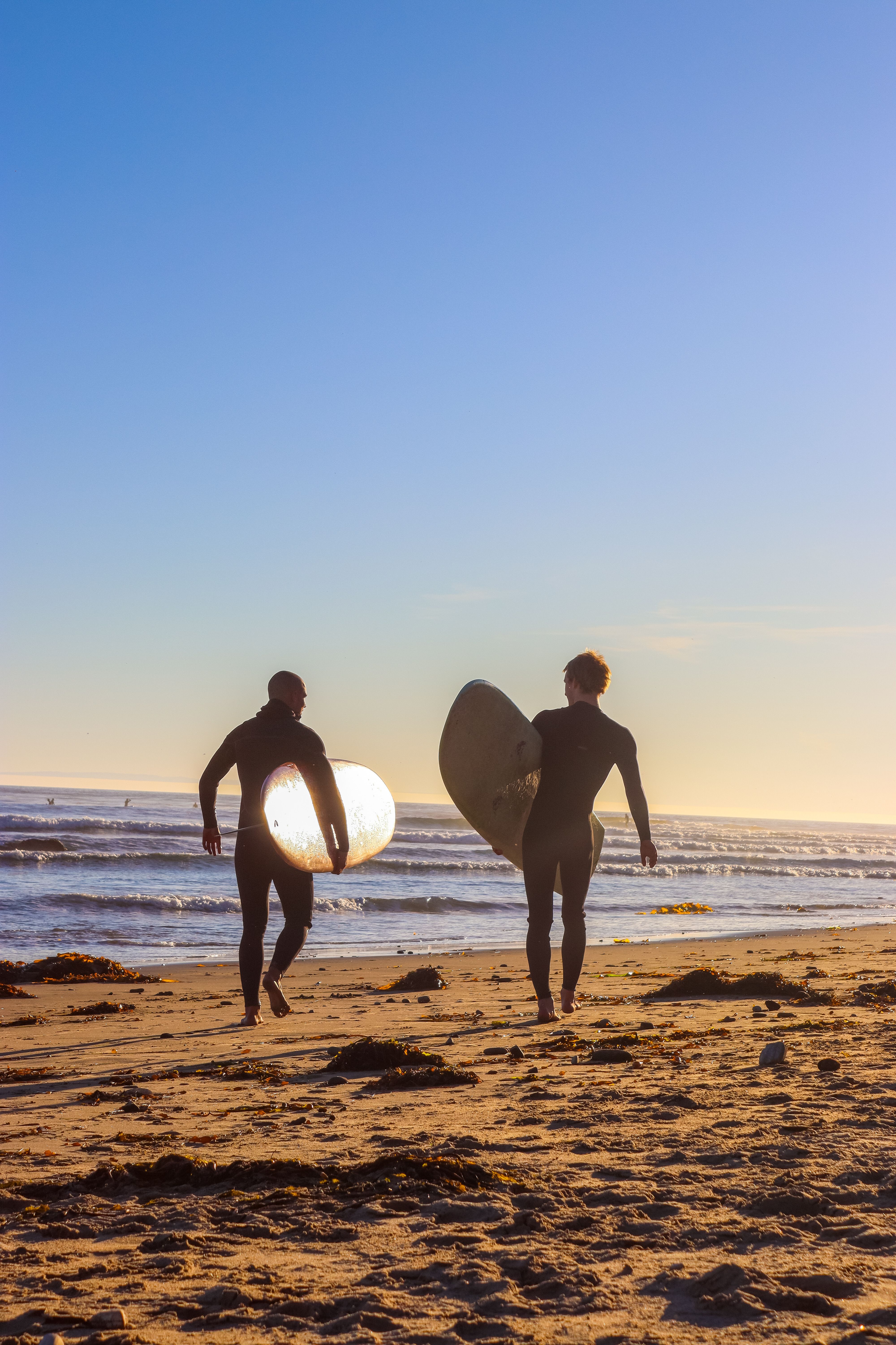 Surfers Walking Beach at Sunrise in Santa Barbara · Free Stock Photo