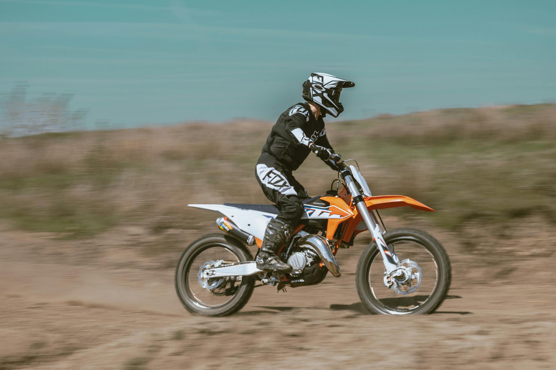 A biker in action on a dirt track, showcasing speed and agility in a thrilling motorcross race.