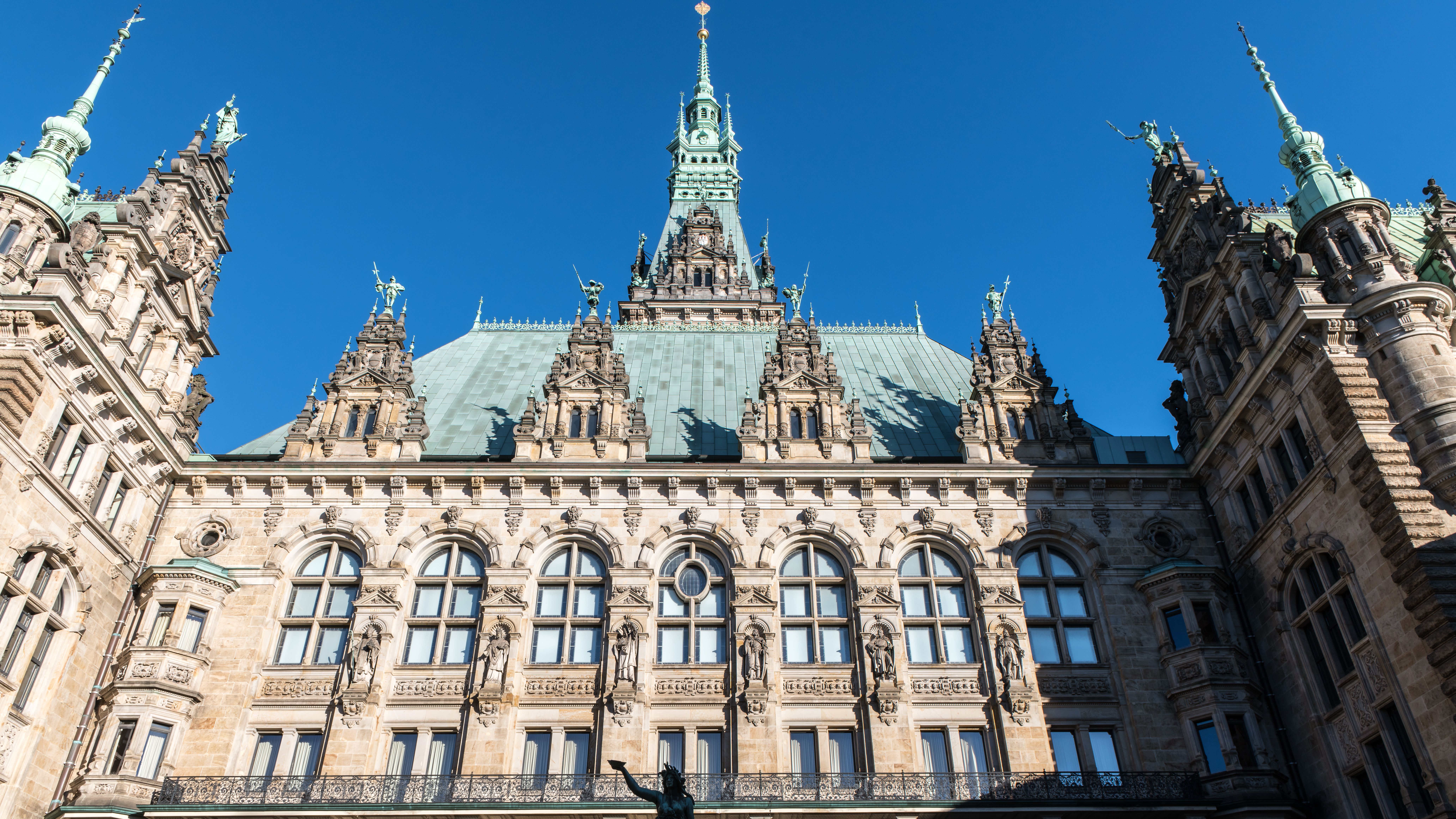Free View of Hamburg Town Hall showcasing intricate historic architecture under a clear blue sky. Stock Photo