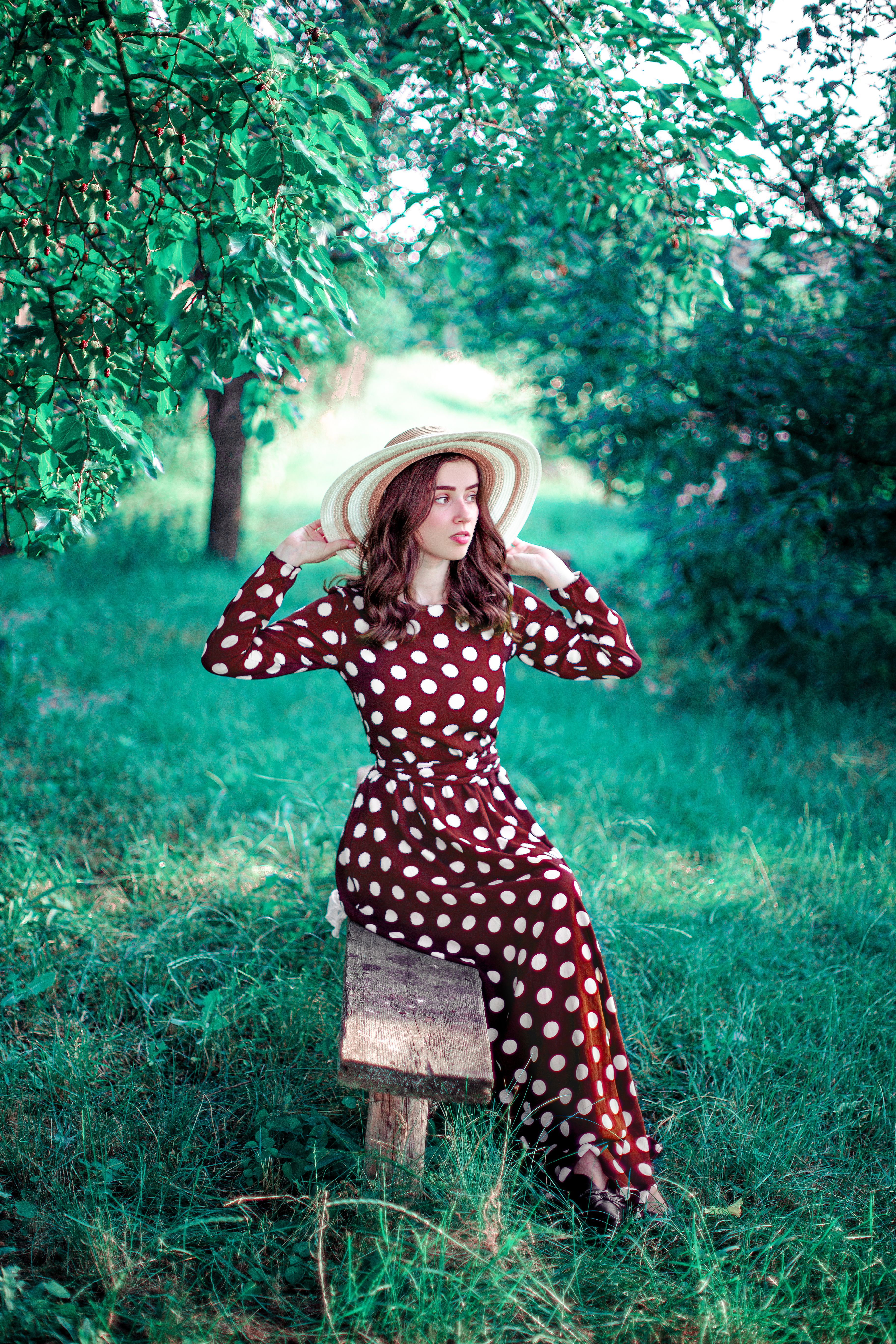 Elegant Woman in Polka Dot Dress Outdoors · Free Stock Photo