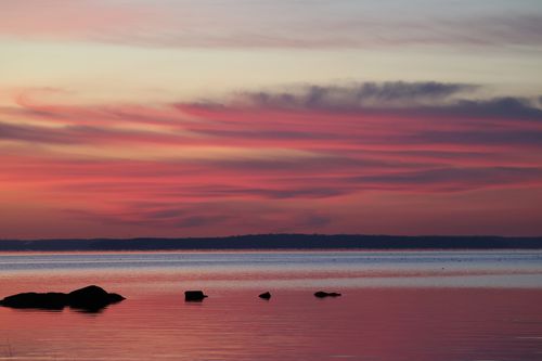 Free Breathtaking sunrise over calm waters in Stamford, Connecticut, showcasing vibrant autumn colors and serene atmosphere. Stock Photo