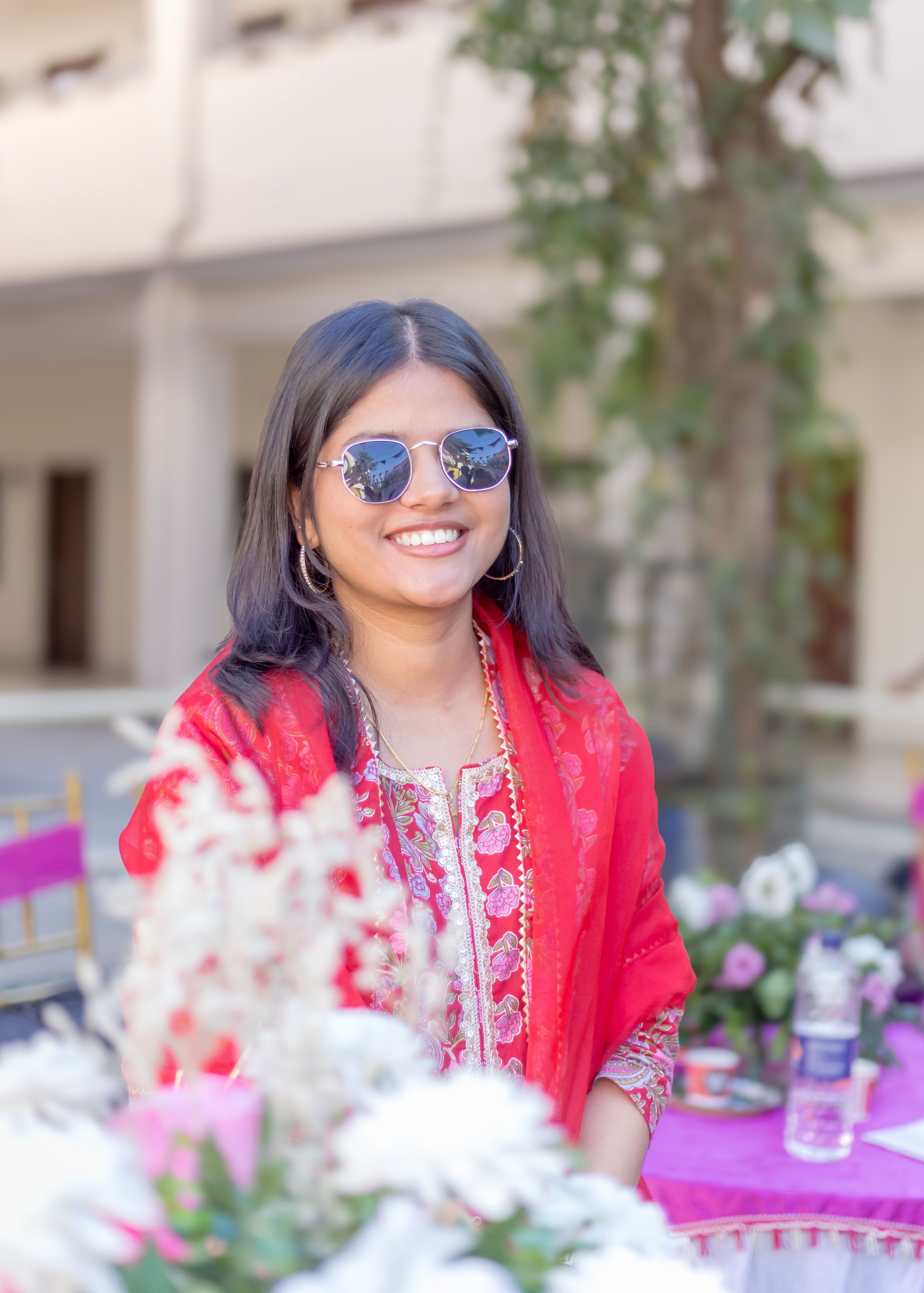 Young Woman in Traditional Attire Smiling Outdoors · Free Stock Photo