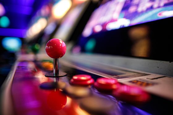 Retro arcade joystick and buttons lit in neon — photo by Dan Butler on Pexels