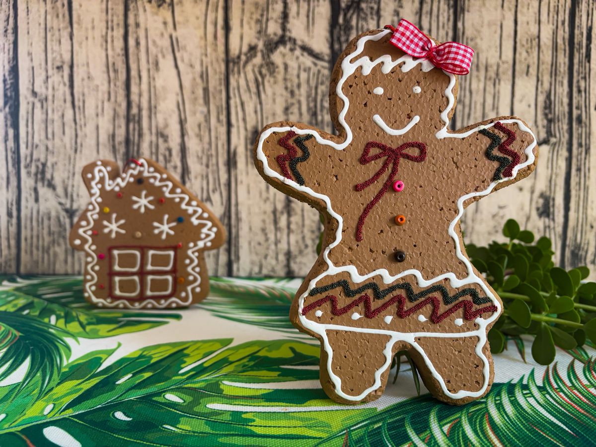Gingerbread cookie and house on a festive tablecloth for melted snowman cookies