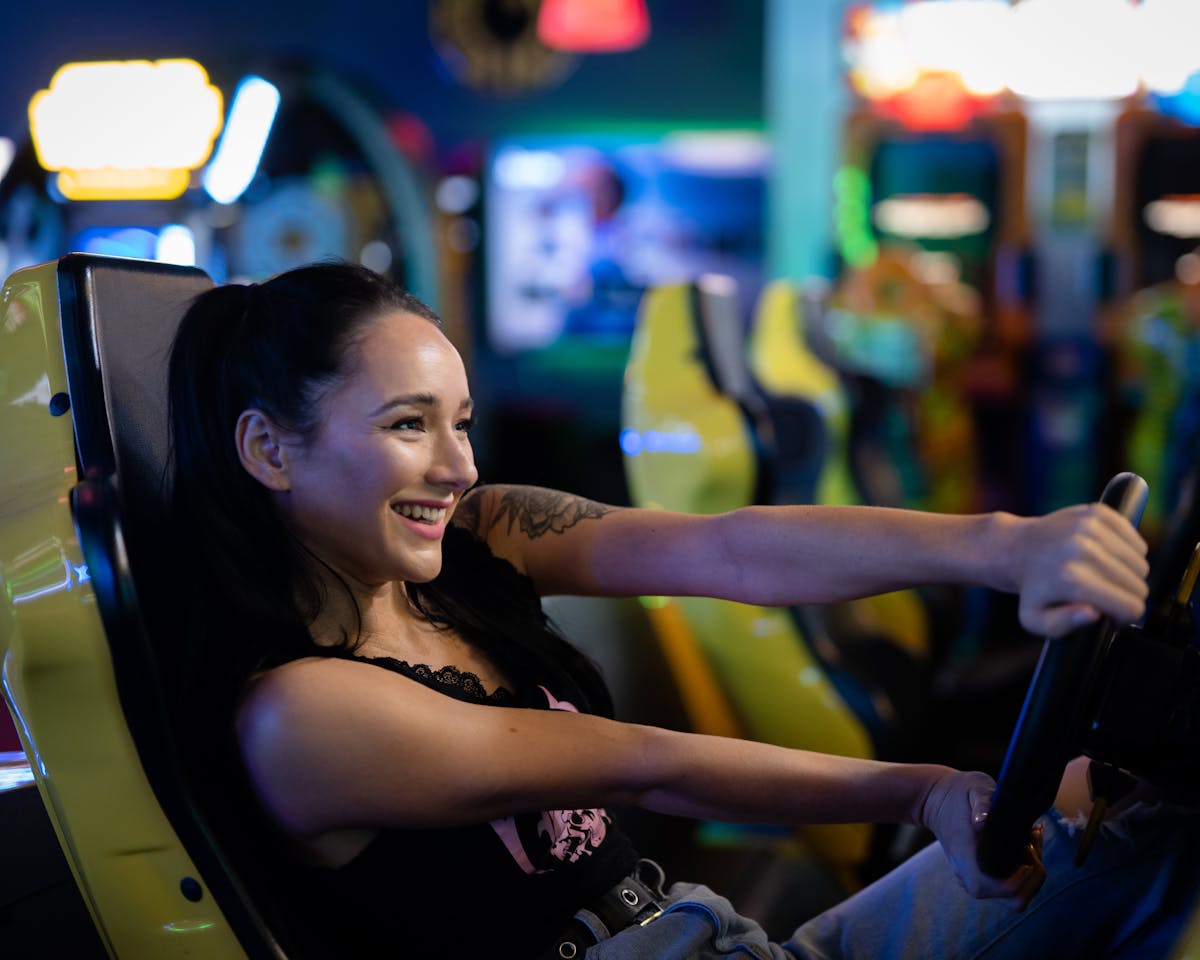 A Couple Sitting at the Arcade Games Seats · Free Stock Photo
