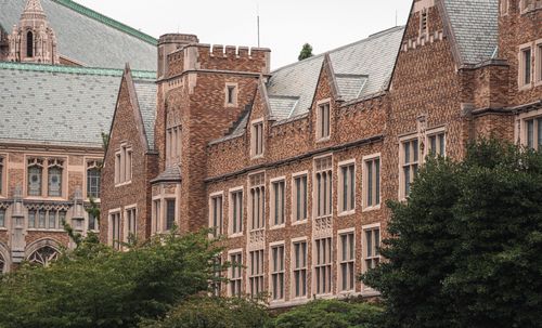 Free View of historic brick building with slate roofs and Gothic architectural features. Stock Photo