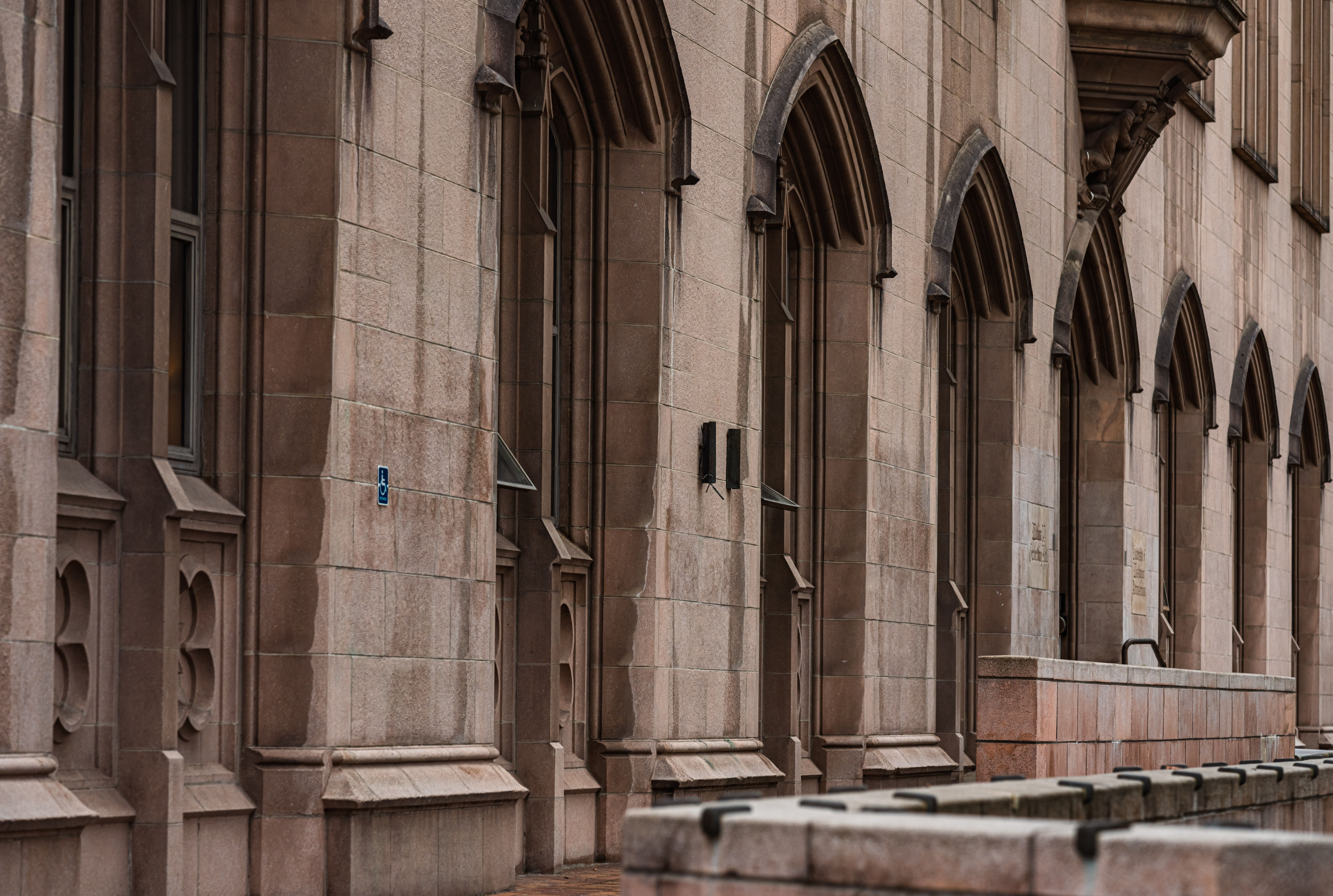 Gothic architectural facade with arched windows and stone details, adding an elegant touch.