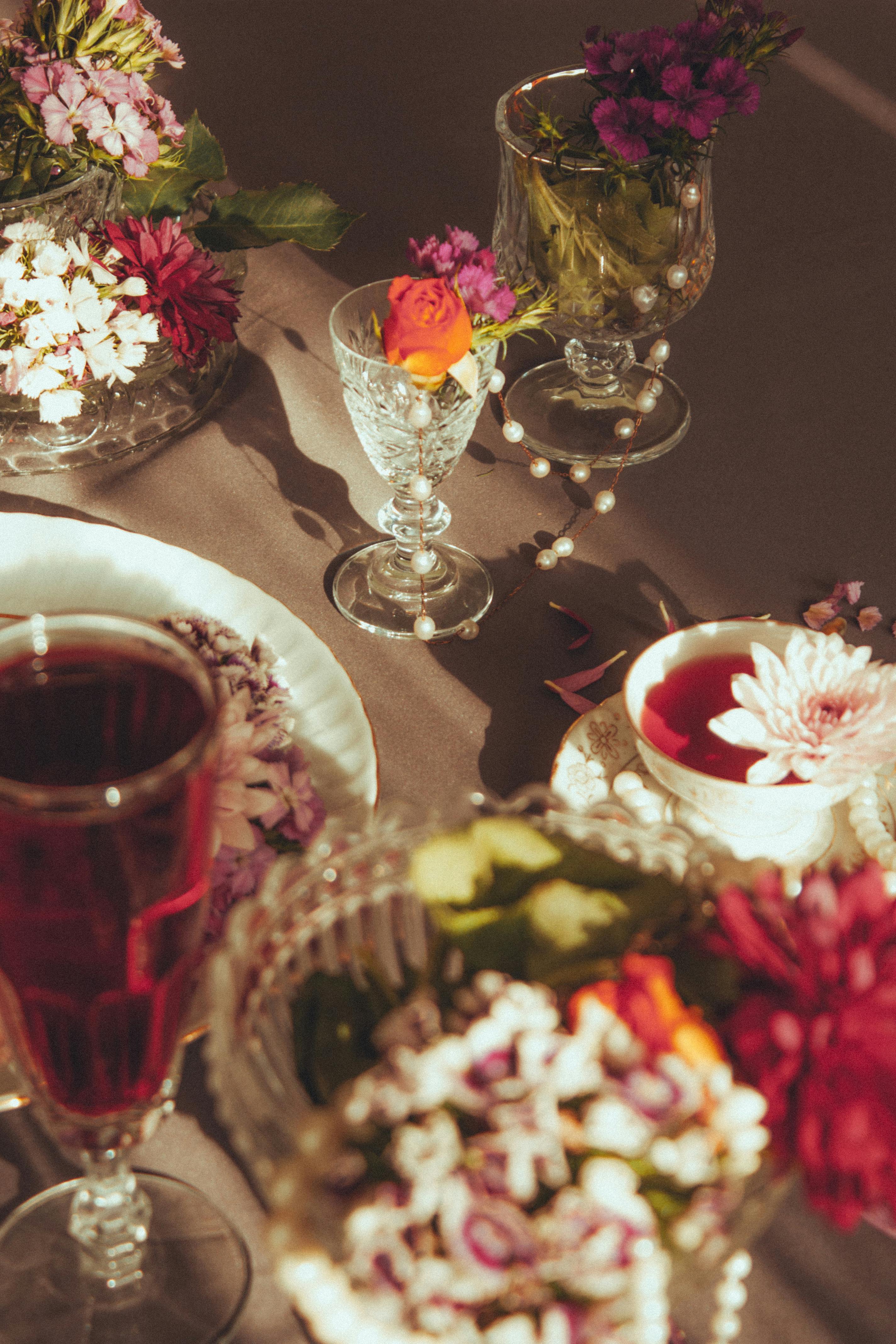 Stylish floral table setting with crystal glasses under warm lighting.