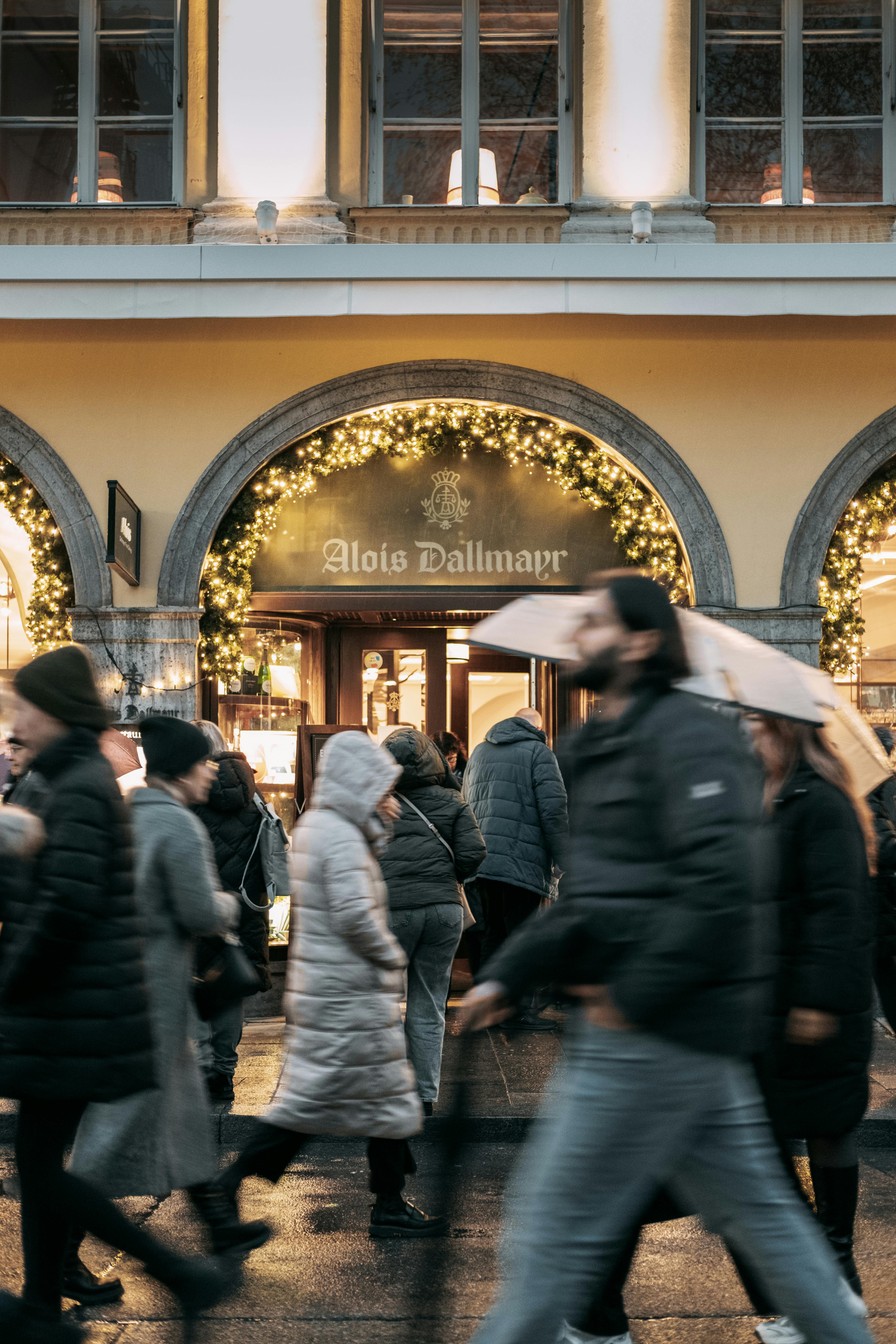 busy street scene at alois dallmayr storefront