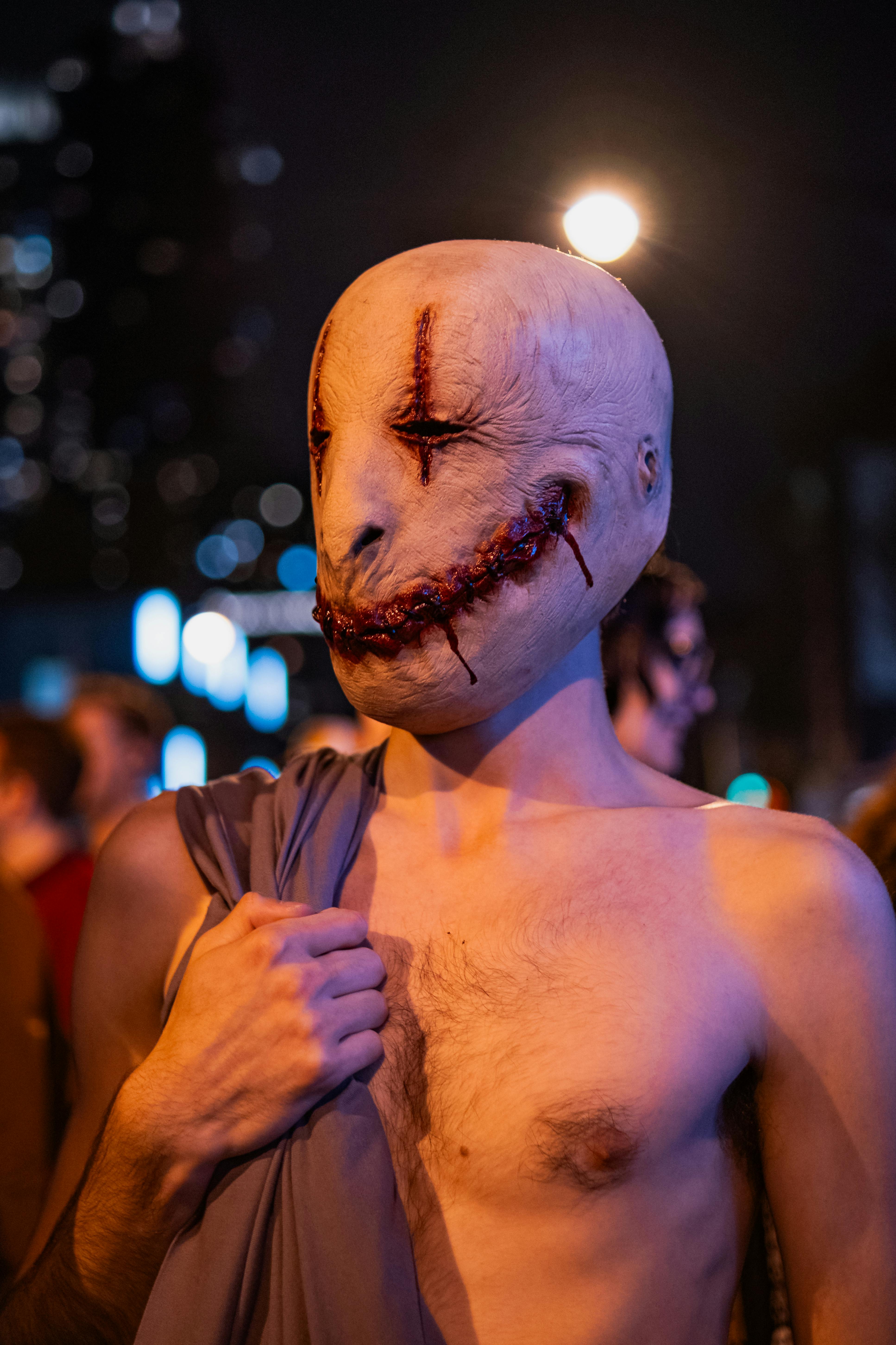 A striking Halloween costume captured in vibrant night street photography.