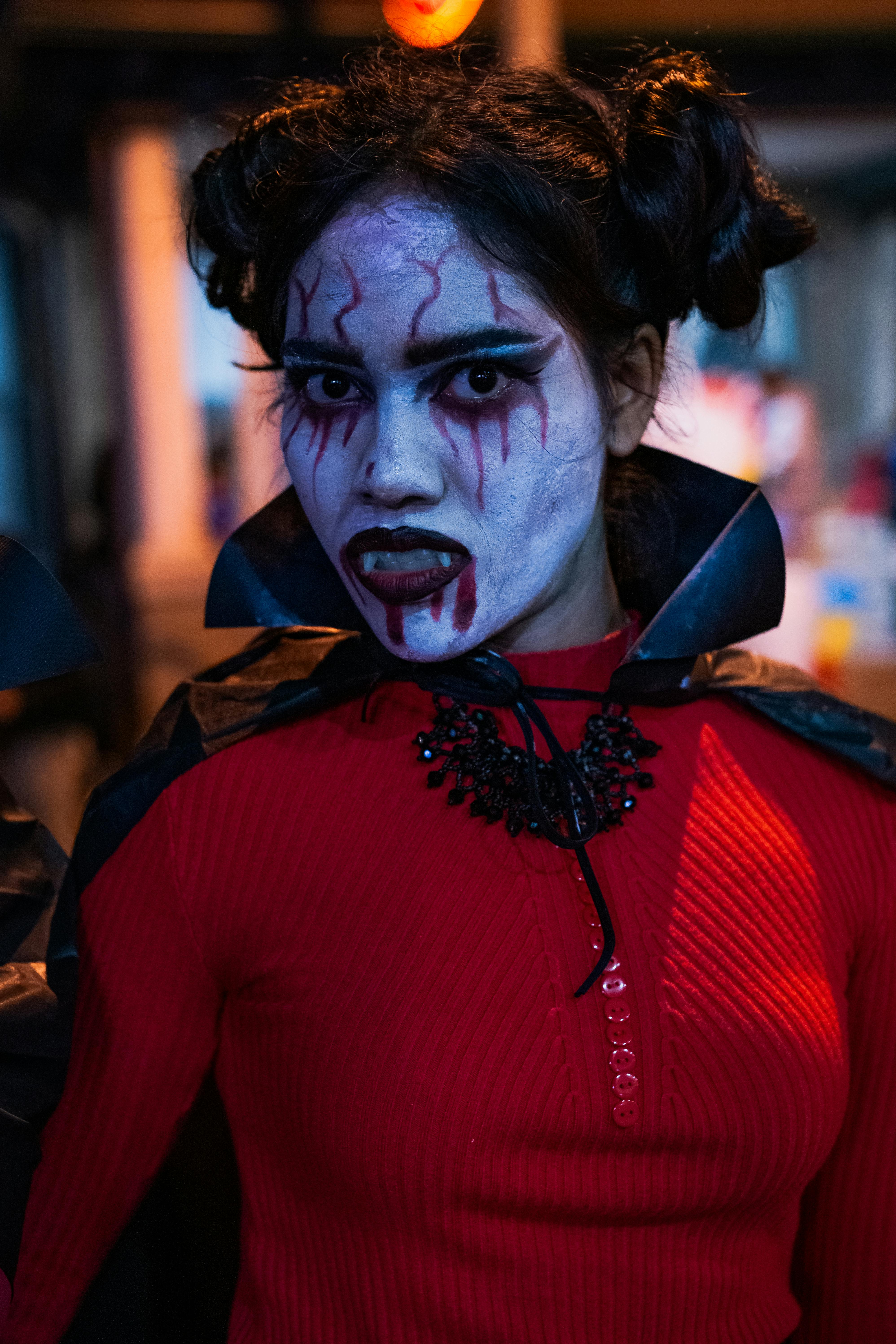 A person in a detailed vampire costume with face paint during Halloween in Toronto.