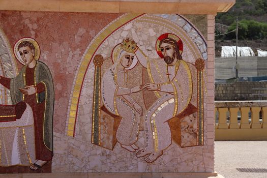 Detailed religious mosaic featuring historical figures on a sunny day.
