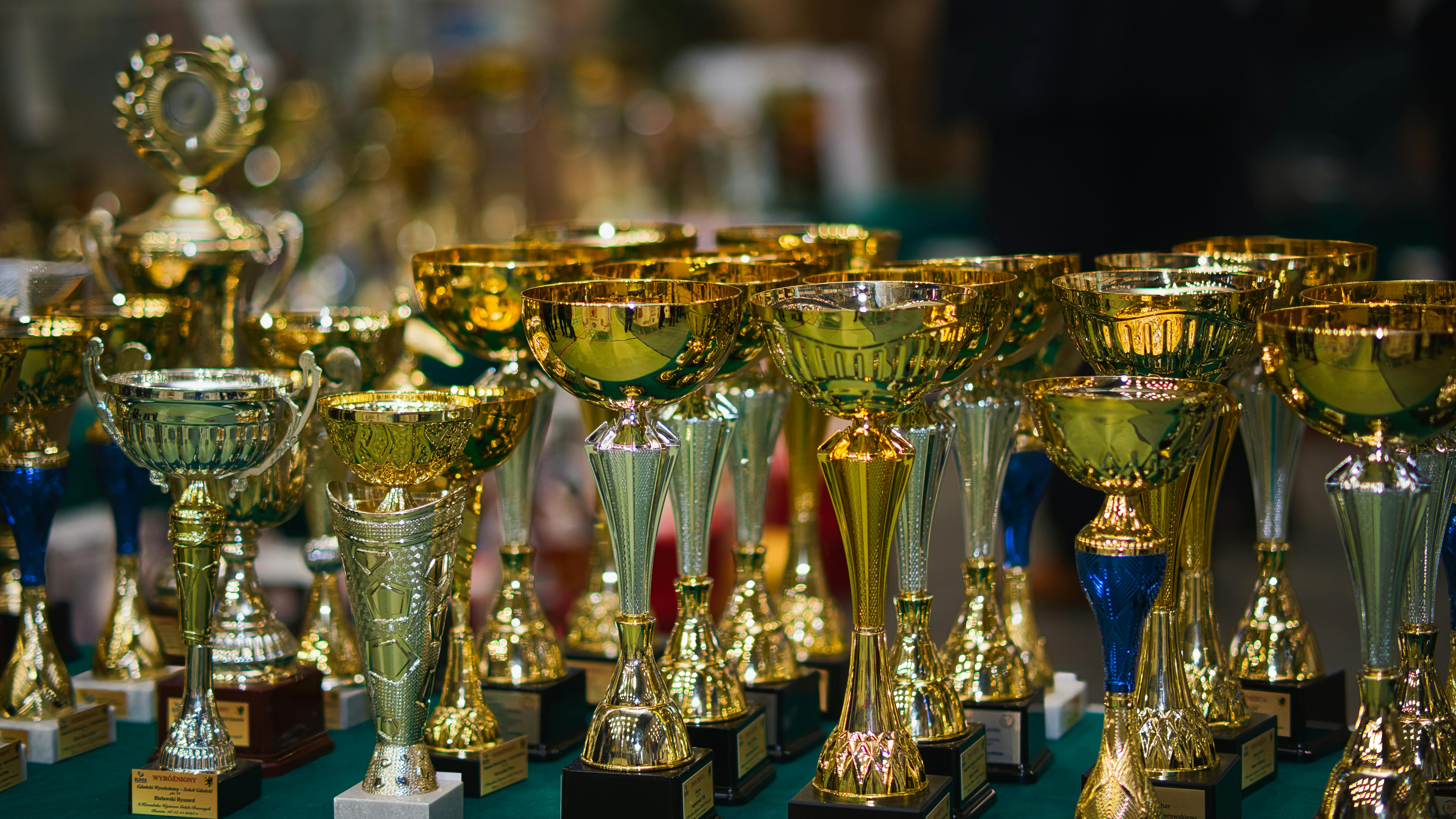 golden trophy collection displayed in a row